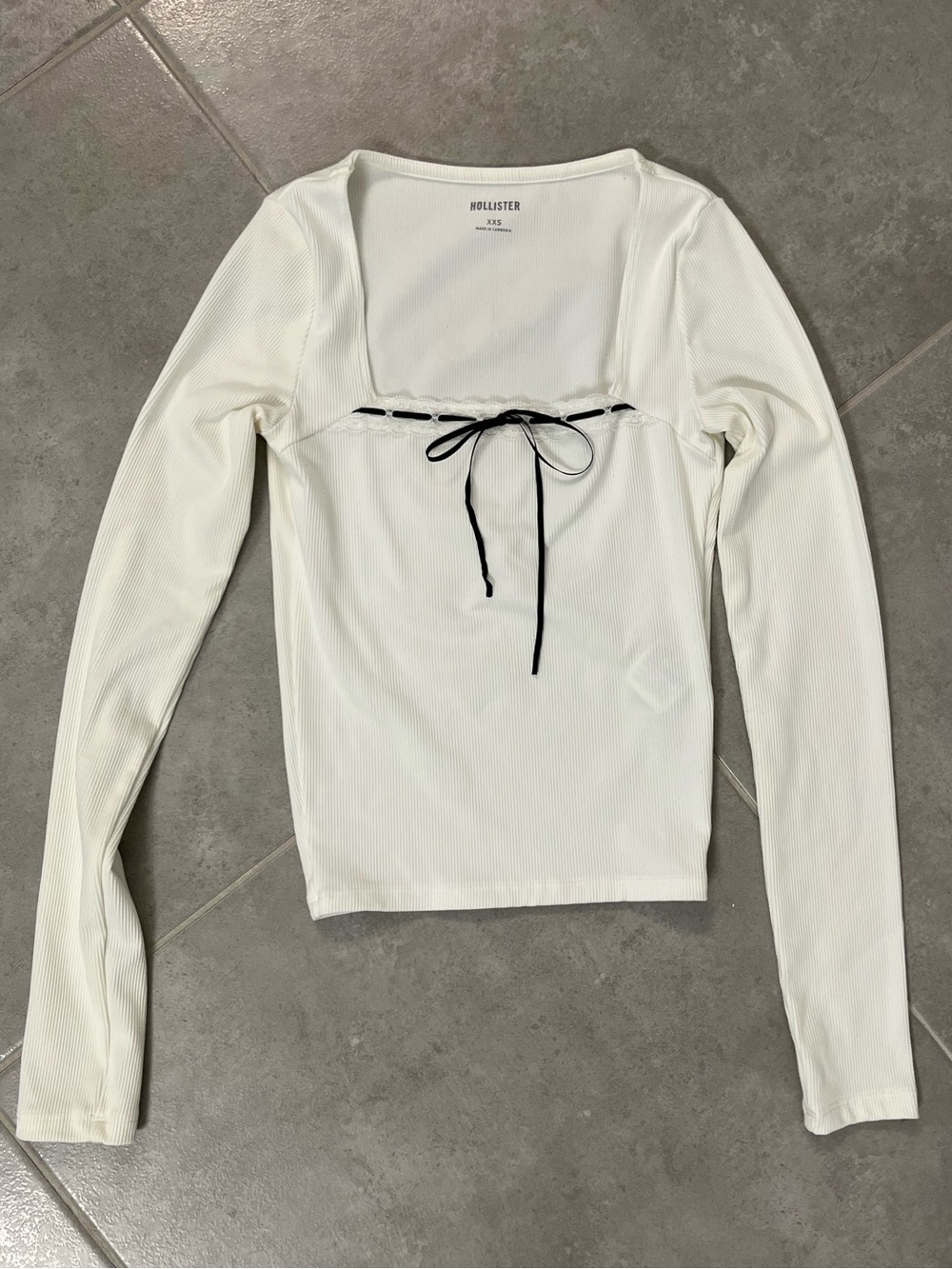 Hollister xxs white long sleeve shirt with white lace and black bow detail.